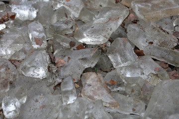 Textured surface of pieces of ice and street dirt