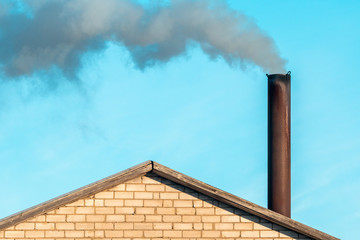 Smoke comes from the chimney of the house