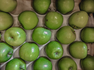  Juicy Organic Apples on a counter in a store.