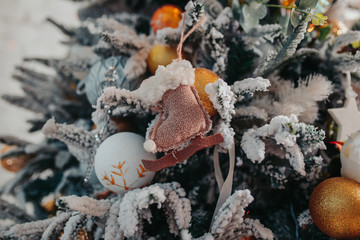 Christmas tree decorations. Different christmas ornaments, angels, balls, snowflakes on the tree. Christmas decorations design.