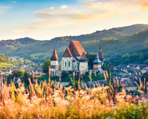 Gorgeous summer view of Fortified Church of Biertan, UNESCO World Heritage Sites since 1993. Captivating morning cityscape of Biertan town, Transylvania, Romania, Europe. - obrazy, fototapety, plakaty