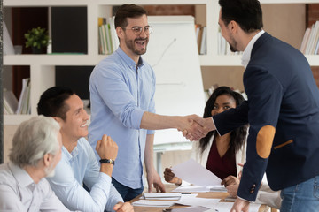 Successful business partners shaking hands starting or finished meeting