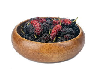 branch of ripe Mulberry (Morus nigra) in brown bowl isolated on white background. concept healthy...