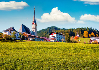 Sunny autumn scene of Pfarramt Catholic Church. Captivating morning view of the Gosau village in...