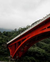 red bridge through the mountain