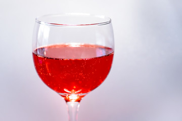 Still life with a red fruit juice glass