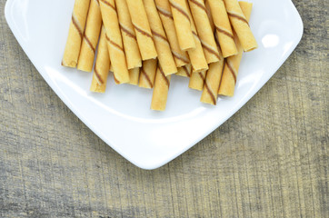 Vanilla waffle roll sticks in white plate