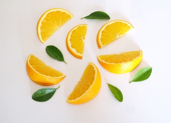 Top view of fresh orange and piece sliced with green leaves isolated on white background.