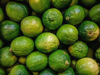Fresh organic lime lemons on a market shelf