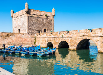 Famous Essaouira fort in Morocco with blue fishing boats