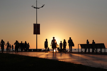 Silhouette people group on sea beach sunset background