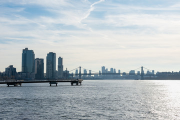 Pier in Greenpoint Brooklyn New York extending out onto the East River with the Williamsburg Bridge in the background