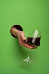 female hand in a circular hole in the background
