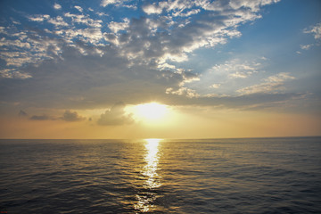 pretty scene of sunrise through the clouds