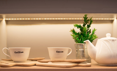 Teapot with cups on the table