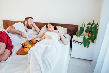 man and woman breakfast in bed morning