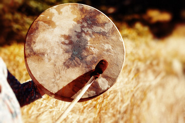 shaman frame drum in woman hand in the nature.