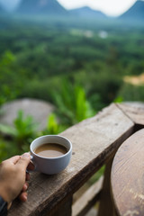 a cup of coffee in mountain landscape