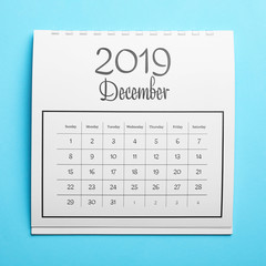 December 2019 calendar on light blue background, top view