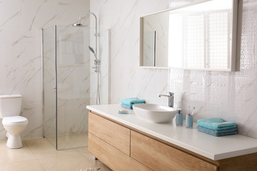 Fototapeta na wymiar Modern mirror and vessel sink in stylish bathroom