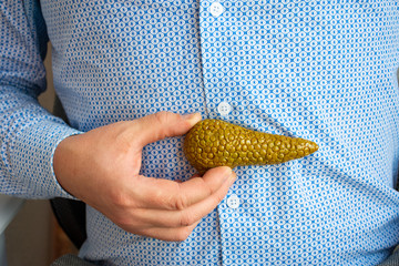 Person - medical specialist or doctor, shows to patient anatomical location of pancreas gland...