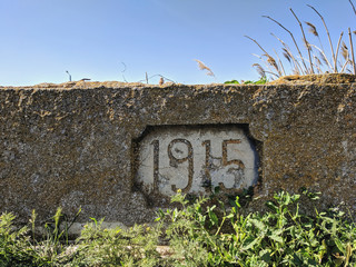 old stone wall with a sign 1915 year