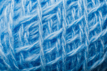 Wool yarn close-up colorful blue threads for needlework in macro.