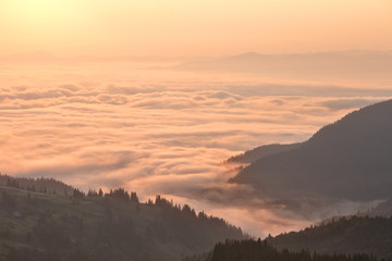 Fototapeta na wymiar Clouds in mountains at sunrise