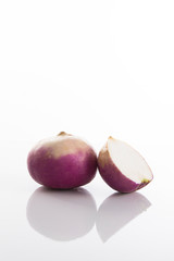 Fresh radish on a white surface with a white background