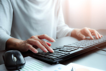 The hand of Asian woman is press, typing on keyboard 2 language is Thai and English of computer. Maybe preparation about information to report, chat to lover or shopping on line by connect to internet