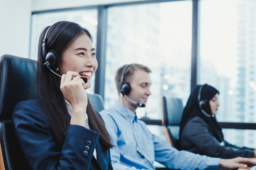 Group of diverse telemarketing customer service staff team in call center.