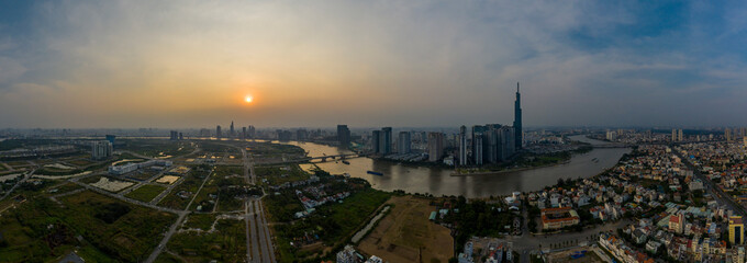 Smoggy Sunset Panorama over Saigon River in Ho Chi Minh City, Vietnam featuring the City Skyline