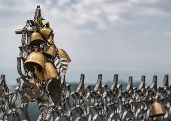 Close-up on decorative golden bells, one of the offerings from pilgrims at Kyaiktiyo Pagoda, Mon State, Myanmar.