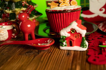 Christmas time. Christmas tableware and decorations. Red and brown colors. Rustic wooden background.