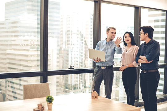 House sales representatives are taking customers to see and offer houses that are selling.