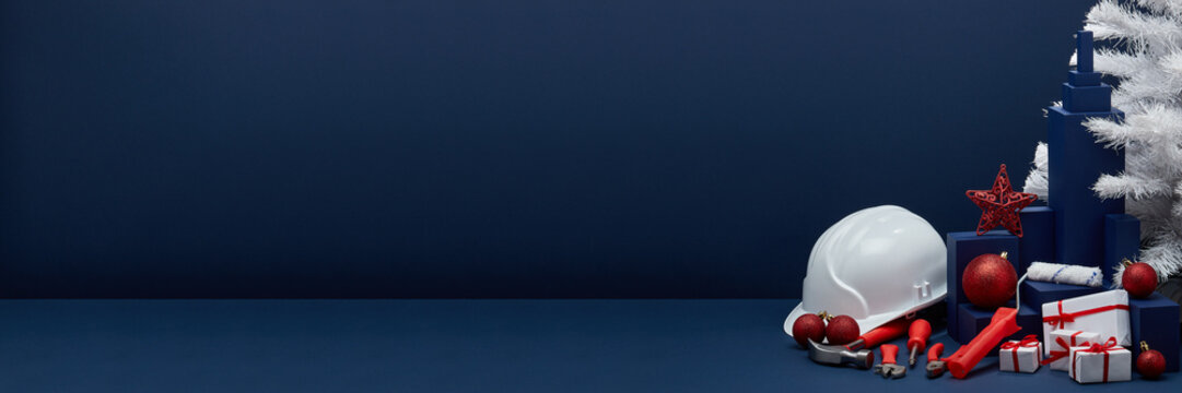 Construction tools, hard hat and Christmas decorations. Christmas and New Year construction Extra wide banner background