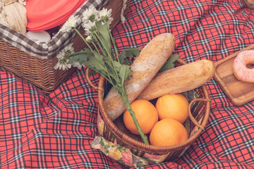 Summer time.Closeup of picnic basket with food and fruit  in nature.