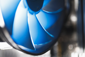 blue cpu cooler inside PC case, shiny light background