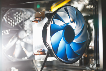 blue cpu cooler inside PC case, shiny light background