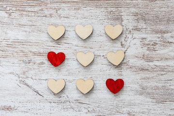 Fototapeta premium Red and white hearts on a wooden background. Valentines day concept