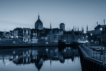Fototapeta na wymiar Evening view of the city river embankment, trendy monochrome classic blue toning