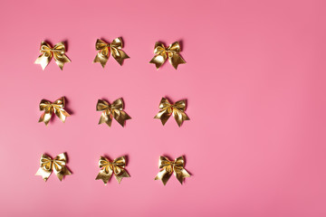 Pink celebration background with golden bows