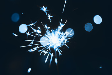 Sparklers on bokeh background. New Year, Christmas, holiday, Thanksgiving, birthday. Surprise, fireworks. Fresh classic Pantone 2020 in blue. Color concept of the year.