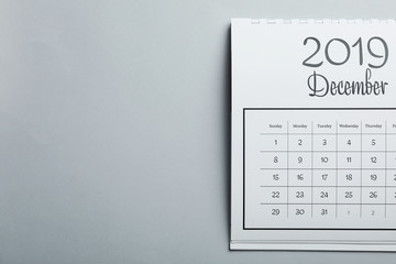 December 2019 calendar on light grey background, top view. Space for text