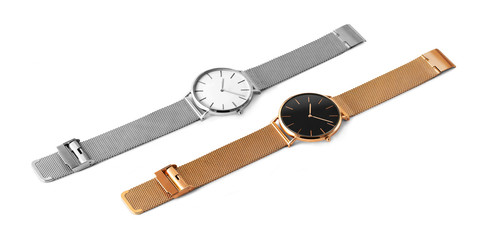 Two expensive wristwatches made of silver and gold metal and isolated on a white background