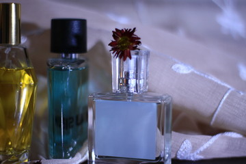 bottle of perfume and flowers on wooden table