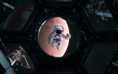 Astronaut on background of Mars. Solar system. View from porthole of spaceship. 3D Render. Science fiction. Elements of this image furnished by NASA