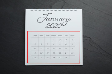 January 2020 calendar on black stone background, top view