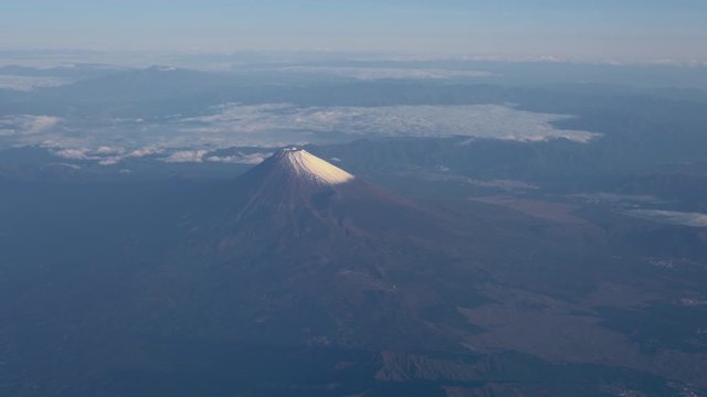A bird's eye view close-up the Mount Fuji ( Mt. Fuji ) and blue sky. Scenery landscapes of the Fuji-Hakone-Izu National Park. Shizuoka Prefecture, Japan. 4K UHD