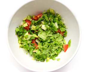 Vegetable salad with avocado, leaves, tomato, sesame seeds, garlic, lemon juice.